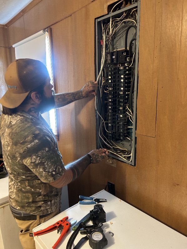 Derik is running wires to the breaker box!